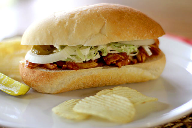 Shredded BBQ chicken sandwich - homemade barbecue sauce with a secret nutty ingredient, shredded poached chicken breast, onions and tangy slaw all on a sub roll