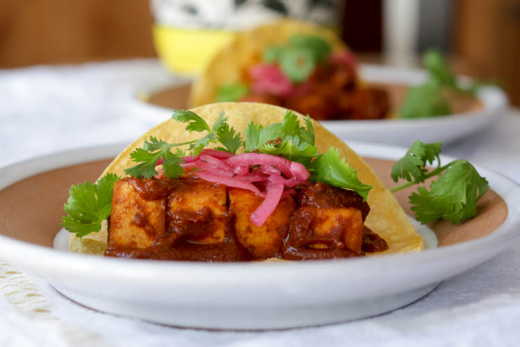 Tofu Mole Tacos! Fried tofu cubes simmered in a homemade vegan mole sauce made with dried chiles, tomatoes, garlic, spices, and sesame seeds