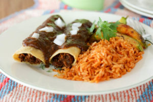 Vegan "beef" enchiladas! Homemade filling with mushrooms, pecans and refried beans topped with homemade vegan Tex-Mex enchilada sauce