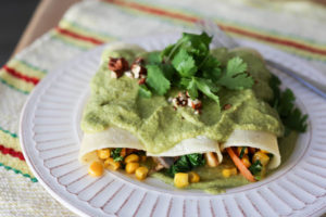 Vegan Enchiladas with Creamy Green Sauce. Vegetable enchiladas filled with carrots, corn, kale and mushrooms. Creamy vegan sauce made of cashews and roasted poblano peppers