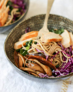 Heathy soba noodle salad bowl with pickled shiitake mushrooms, kale and a soy-ginger vinaigrette. Use chicken or tofu to make it vegan