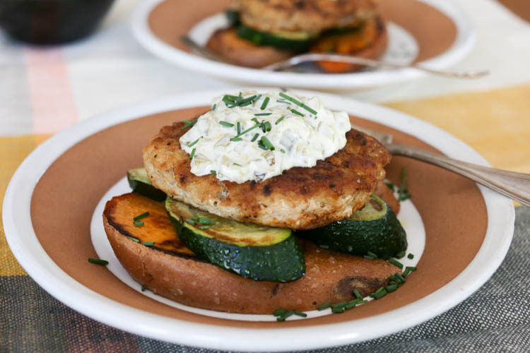 Healthy, low-carb, grain-free turkey burger "stacks" with a layer of fried sweet potato, spiced turkey patty and creamy green chile sauce