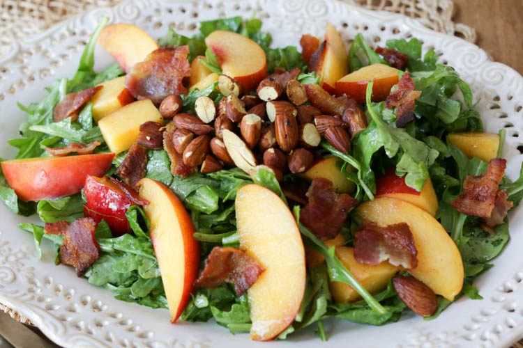 Wonderful main-dish summer salad with fresh peaches or nectarines, crispy bacon, toasted almonds, and arugula in a simple, homemade honey mustard dressing