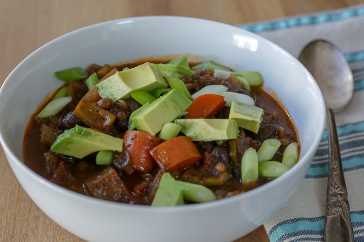 Easy vegetable chili with black beans, lentils, carrots and chayote. This vegan chili will warm your butt