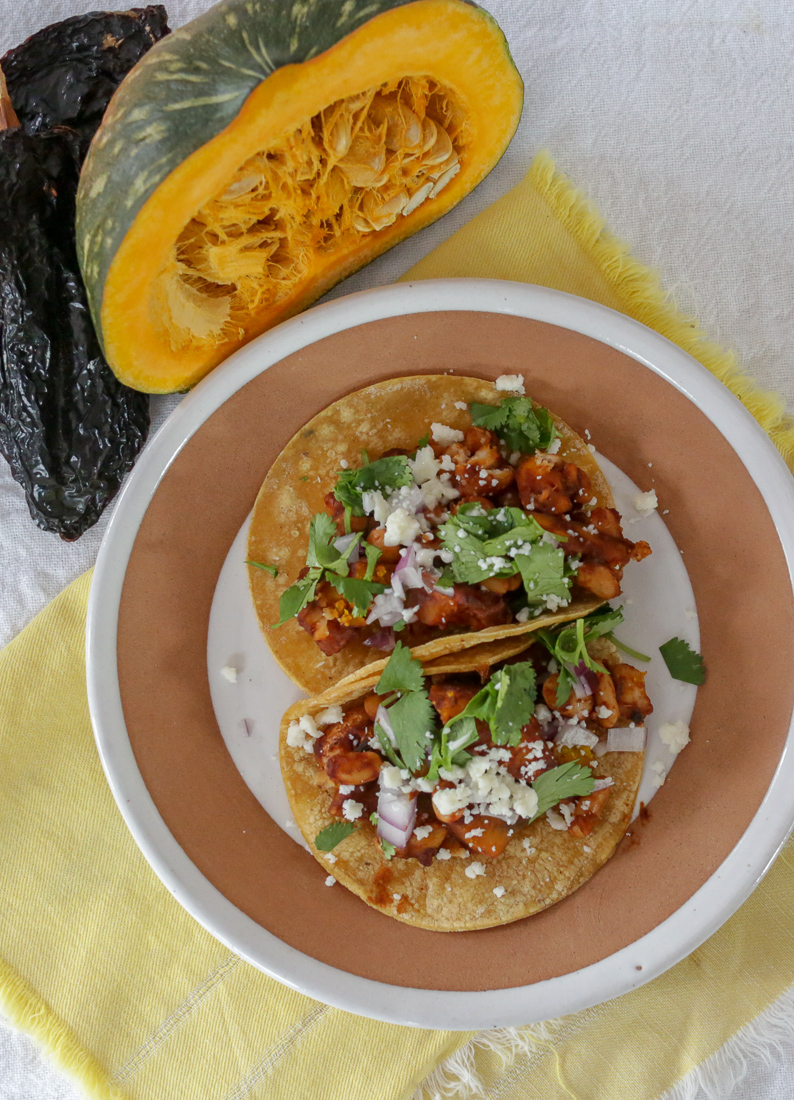 Easy vegan or vegetarian tacos with white beans, pumpkin, and ancho chile salsa. Pumpkin tacos are perfect for meal prepping and Meatless Mondays