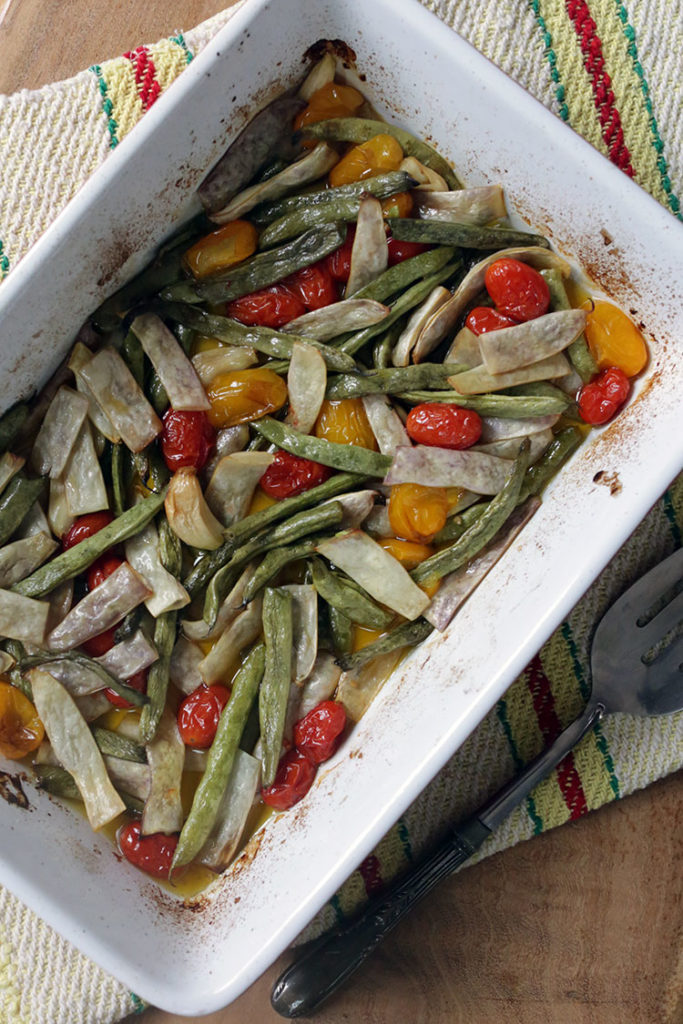 Roasted fresh green beans with cherry tomatoes, olive oil, garlic and salt. A simple side dish or vegan mean dish served with pasta