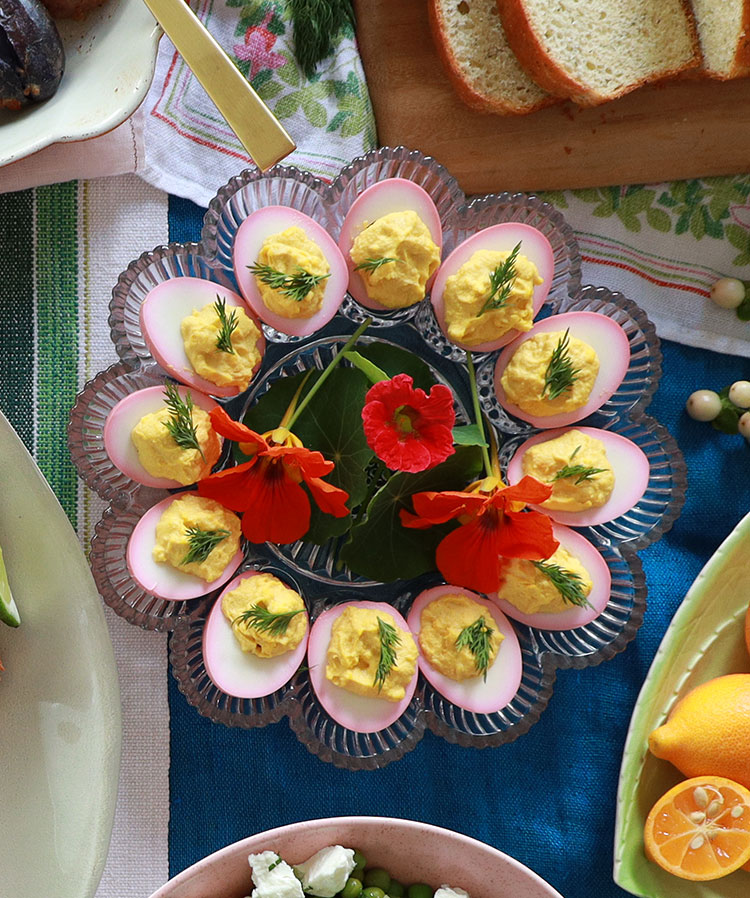 Pickled pink deviled eggs for Easter. Soaking your peeled, boiled eggs in pickled beet juice before deviling them results in beautiful colorful deviled eggs