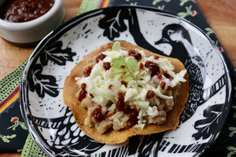 baked tostadas with refried beans and cabbage
