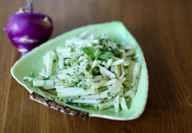 Kohlrabi slaw with herbed green goddess dressing in a green dish