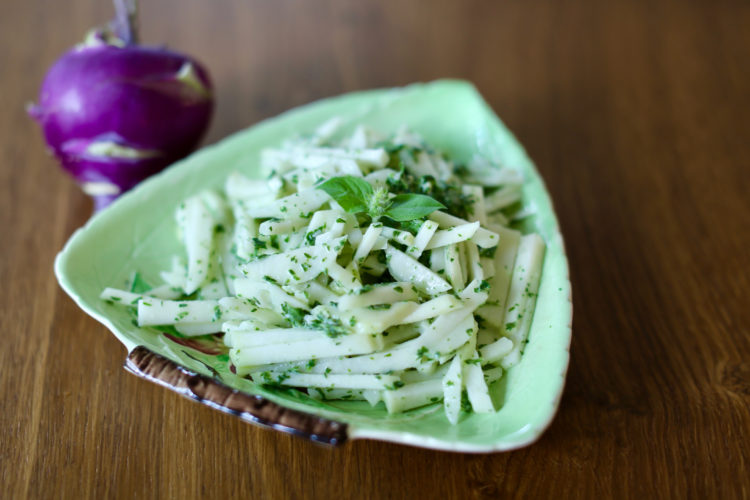 Kohlrabi slaw with herbed green goddess dressing in a green dish