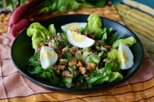 Breakfast salad with lettuce, simple vinaigrette, boiled eggs, sunflower seeds