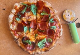 homemade pepperoni pizza with fresh basil
