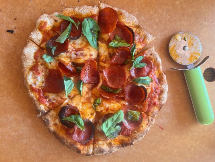 homemade pepperoni pizza with fresh basil