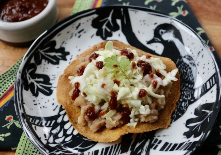 baked tostadas with refried beans and cabbage