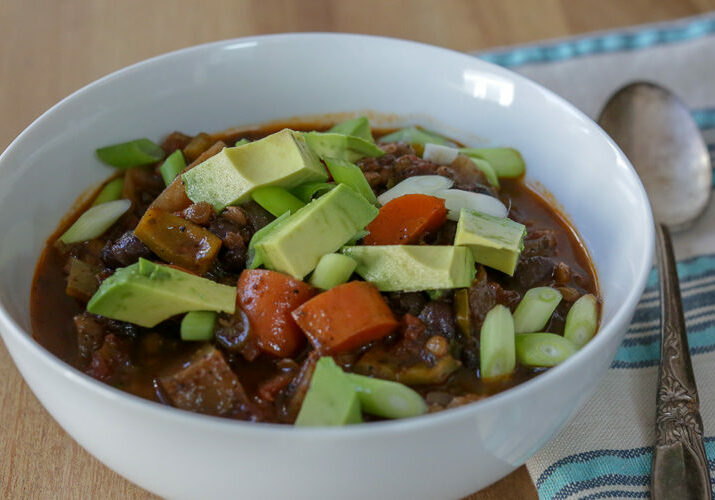 Easy vegetable chili with black beans, lentils, carrots and chayote. This vegan chili will warm your butt